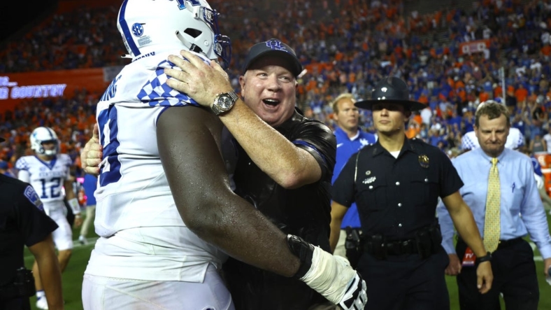 Sep 10, 2022; Gainesville, Florida, USA; Kentucky Wildcats head coach Mark Stoops and offensive lineman Tashawn Manning (79) celebrate after they beat the Florida Gators at Ben Hill Griffin Stadium. Mandatory Credit: Kim Klement-USA TODAY Sports