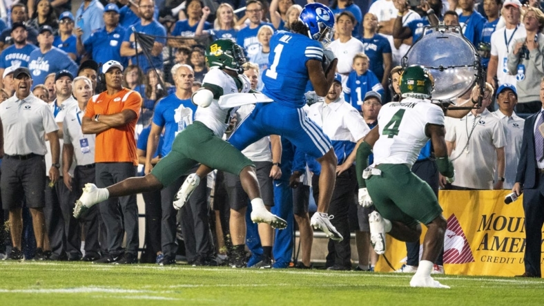 Sep 10, 2022; Provo, Utah, USA; Brigham Young Cougars wide receiver Keanu Hill (1) catches a pass against Baylor Bears safety Al Walcott (13) and safety Christian Morgan (4) in the first half at LaVell Edwards Stadium. Mandatory Credit: Gabriel Mayberry-USA TODAY Sports