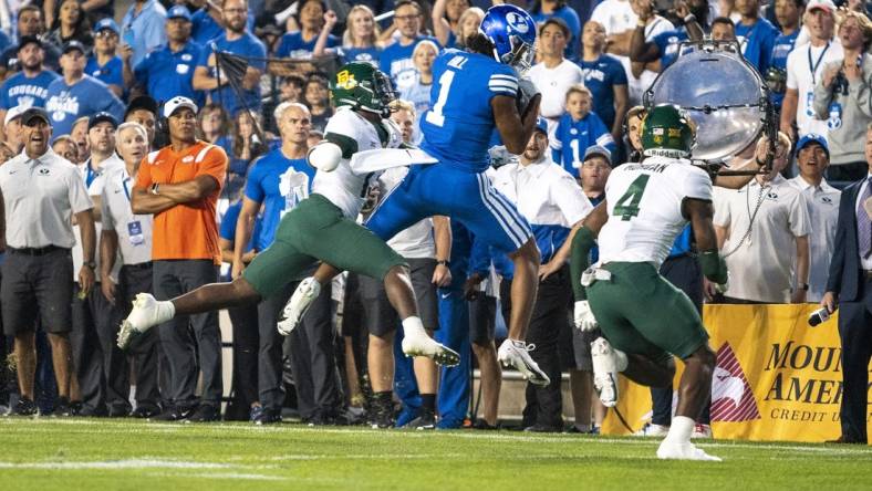 Sep 10, 2022; Provo, Utah, USA; Brigham Young Cougars wide receiver Keanu Hill (1) catches a pass against Baylor Bears safety Al Walcott (13) and safety Christian Morgan (4) in the first half at LaVell Edwards Stadium. Mandatory Credit: Gabriel Mayberry-USA TODAY Sports