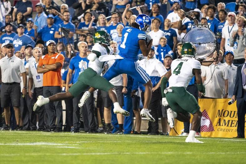 Sep 10, 2022; Provo, Utah, USA; Brigham Young Cougars wide receiver Keanu Hill (1) catches a pass against Baylor Bears safety Al Walcott (13) and safety Christian Morgan (4) in the first half at LaVell Edwards Stadium. Mandatory Credit: Gabriel Mayberry-USA TODAY Sports