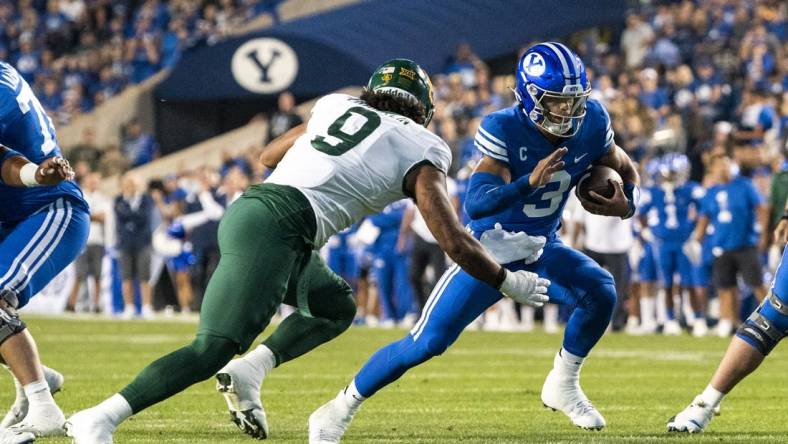 Sep 10, 2022; Provo, Utah, USA; Brigham Young Cougars quarterback Jaren Hall (3) runs the ball against Baylor Bears defensive lineman TJ Franklin (9) during the first half at LaVell Edwards Stadium. Mandatory Credit: Gabriel Mayberry-USA TODAY Sports