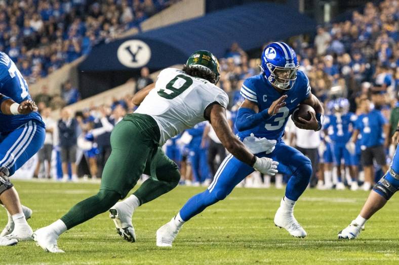 Sep 10, 2022; Provo, Utah, USA; Brigham Young Cougars quarterback Jaren Hall (3) runs the ball against Baylor Bears defensive lineman TJ Franklin (9) during the first half at LaVell Edwards Stadium. Mandatory Credit: Gabriel Mayberry-USA TODAY Sports