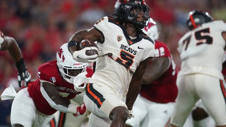 Sep 10, 2022; Fresno, California, USA; Oregon State Beavers running back Deshaun Fenwick (5) runs the ball against the Fresno State Bulldogs in the first quarter at Valley Children's Stadium. Mandatory Credit: Cary Edmondson-USA TODAY Sports