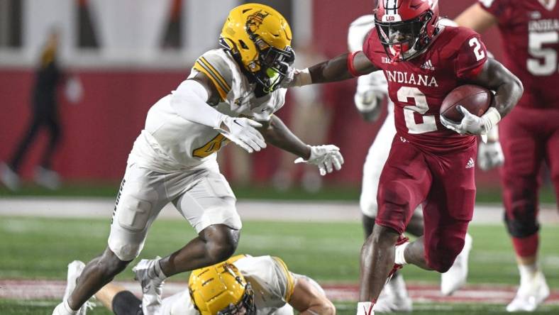 Sep 10, 2022; Bloomington, Indiana, USA;  Indiana Hoosiers running back Shaun Shivers (2) stiff arms Idaho Vandals defensive back Murvin Kenion III (0) during the second half at Memorial Stadium. The Hoosiers won 35-22.  Mandatory Credit: Marc Lebryk-USA TODAY Sports