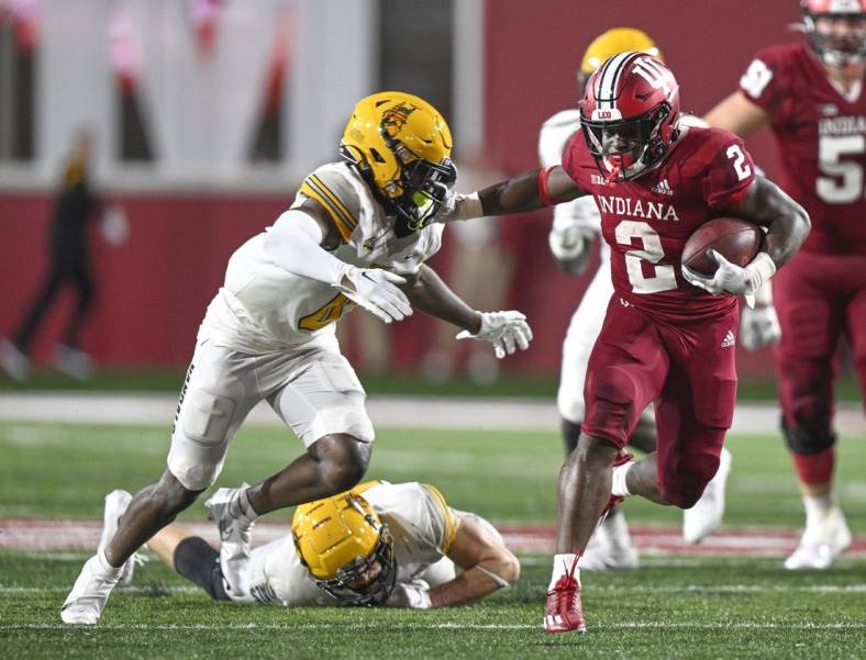 Sep 10, 2022; Bloomington, Indiana, USA;  Indiana Hoosiers running back Shaun Shivers (2) stiff arms Idaho Vandals defensive back Murvin Kenion III (0) during the second half at Memorial Stadium. The Hoosiers won 35-22.  Mandatory Credit: Marc Lebryk-USA TODAY Sports