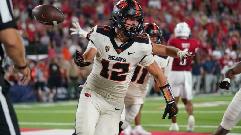 Sep 10, 2022; Fresno, California, USA; Oregon State Beavers running back Jack Colletto (12) flips the ball to an official after scoring a touchdown against the Fresno State Bulldogs on the final play of the game at Valley Children's Stadium. Mandatory Credit: Cary Edmondson-USA TODAY Sports