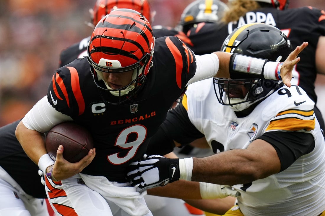 Sep 11, 2022; Cincinnati, Ohio, USA; Cincinnati Bengals quarterback Joe Burrow (9) is defended by Pittsburgh Steelers defensive tackle Cameron Heyward (97) during the first quarter of a Week 1 NFL football game at Paycor Stadium. Mandatory Credit: Sam Greene-USA TODAY Sports