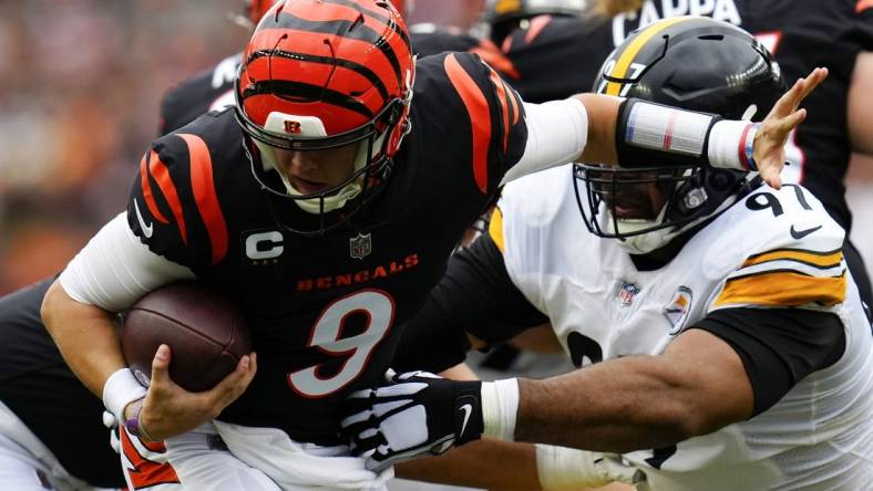 Sep 11, 2022; Cincinnati, Ohio, USA; Cincinnati Bengals quarterback Joe Burrow (9) is defended by Pittsburgh Steelers defensive tackle Cameron Heyward (97) during the first quarter of a Week 1 NFL football game at Paycor Stadium. Mandatory Credit: Sam Greene-USA TODAY Sports