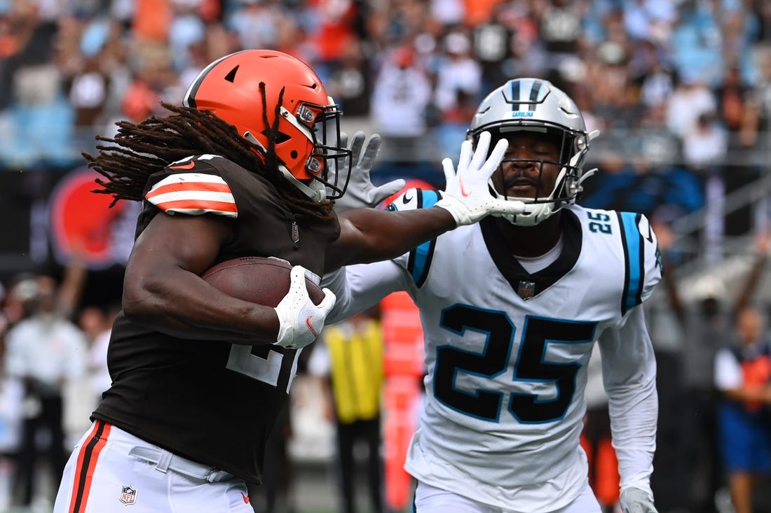 Sep 11, 2022; Charlotte, North Carolina, USA; Carolina Panthers safety Marquise Blair (27) runs for a touchdown   as Carolina Panthers Xavier Woods (25) defends in the second quarter at Bank of America Stadium. Mandatory Credit: Bob Donnan-USA TODAY Sports