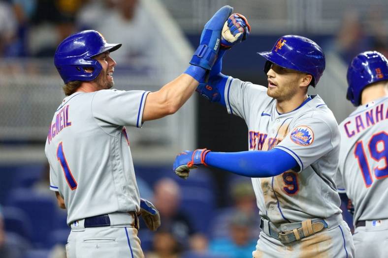 Sep 11, 2022; Miami, Florida, USA;  New York Mets second baseman Jeff McNeil (1) congratulates center fielder Brandon Nimmo (9) after hitting a three-ru home run against the Miami Marlins in the second inning at loanDepot Park. Mandatory Credit: Nathan Ray Seebeck-USA TODAY Sports