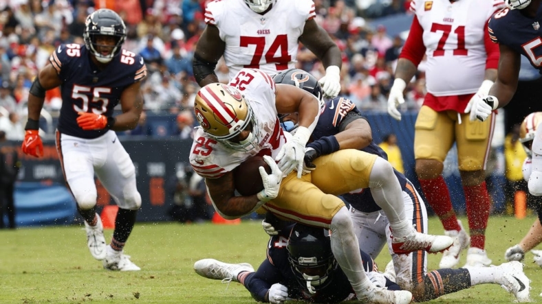 Sep 11, 2022; Chicago, Illinois, USA; San Francisco 49ers running back Elijah Mitchell (25) rushes the ball against Chicago Bears safety Jaquan Brisker (9) during the first half at Soldier Field. Mandatory Credit: Mike Dinovo-USA TODAY Sports