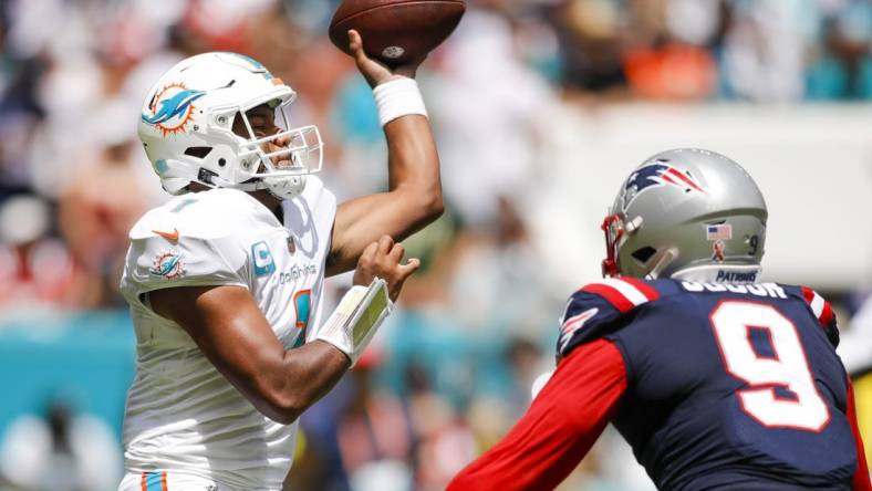 Sep 11, 2022; Miami Gardens, Florida, USA; Miami Dolphins quarterback Tua Tagovailoa (1) throws the football during the second quarter as New England Patriots linebacker Matthew Judon (9) defends during the second quarter at Hard Rock Stadium. Mandatory Credit: Sam Navarro-USA TODAY Sports