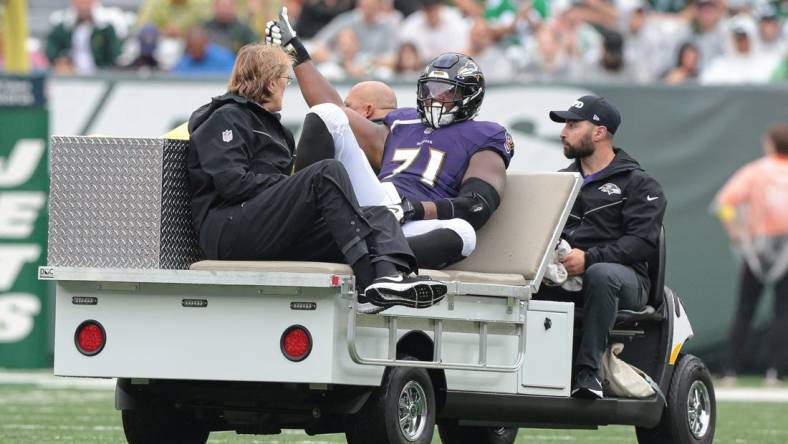 Sep 11, 2022; East Rutherford, New Jersey, USA; Baltimore Ravens offensive tackle Ja'Wuan James (71) is driven off the field after an injury during the first half against the New York Jets at MetLife Stadium. Mandatory Credit: Vincent Carchietta-USA TODAY Sports