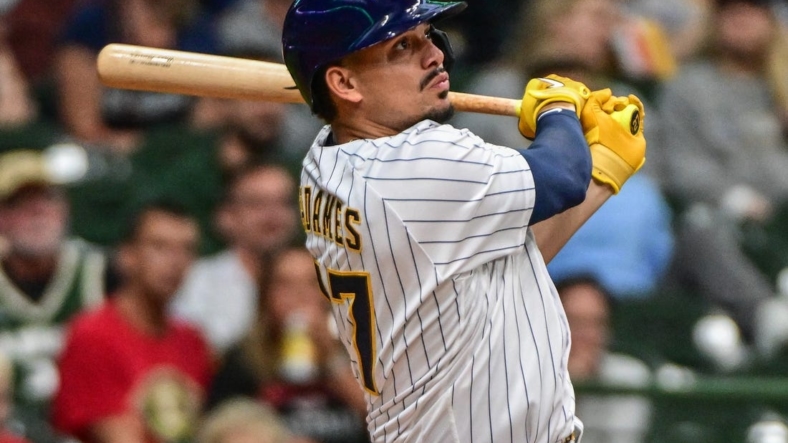 Sep 11, 2022; Milwaukee, Wisconsin, USA; Milwaukee Brewers shortstop Willy Adames (27) hits a 2-run home run in the second inning against the Cincinnati Reds at American Family Field. Mandatory Credit: Benny Sieu-USA TODAY Sports