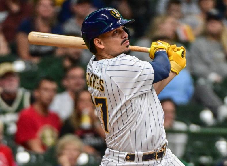 Sep 11, 2022; Milwaukee, Wisconsin, USA; Milwaukee Brewers shortstop Willy Adames (27) hits a 2-run home run in the second inning against the Cincinnati Reds at American Family Field. Mandatory Credit: Benny Sieu-USA TODAY Sports
