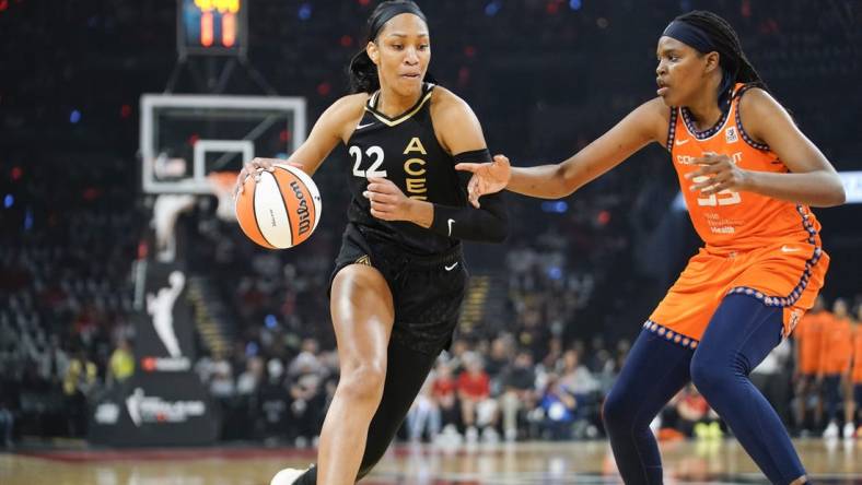 Sep 11, 2022; Las Vegas, Nevada, USA; Las Vegas Aces forward A'ja Wilson (22) drives the ball against Connecticut Sun forward Jonquel Jones (35) in the first quarter during game one of the 2022 WNBA Finals at Michelob Ultra Arena. Mandatory Credit: Lucas Peltier-USA TODAY Sports