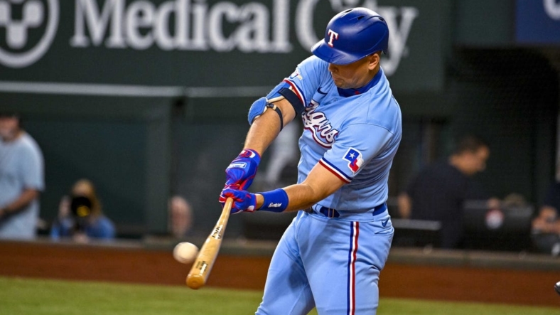 Sep 11, 2022; Arlington, Texas, USA; Texas Rangers first baseman Nathaniel Lowe (30) hits a single and drives in a run against the Toronto Blue Jays during the first inning at Globe Life Field. Mandatory Credit: Jerome Miron-USA TODAY Sports