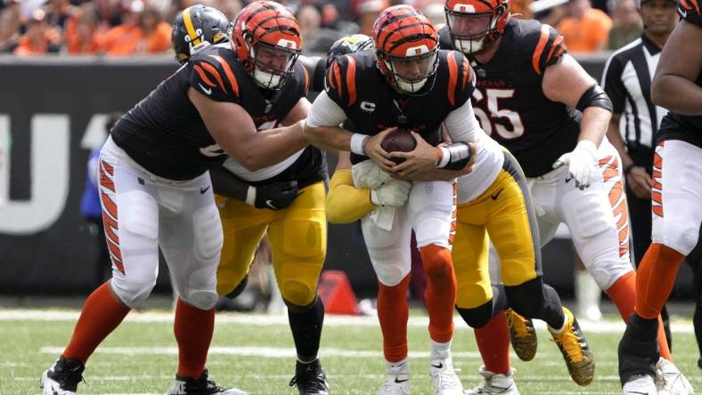 Sep 11, 2022; Cincinnati, Ohio, USA; Cincinnati Bengals quarterback Joe Burrow (9) is sacked by Pittsburgh Steelers linebacker T.J. Watt (90) during the third quarter of a Week 1 NFL football game at Paycor Stadium. Mandatory Credit: Cara Owsley-USA TODAY Sports