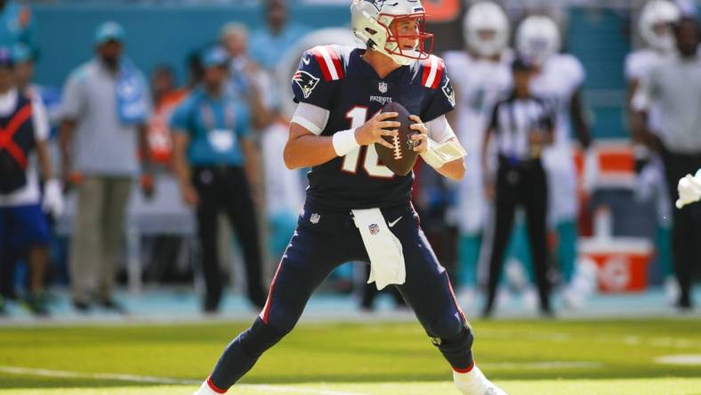 Sep 11, 2022; Miami Gardens, Florida, USA; New England Patriots quarterback Mac Jones (10) watches from the field prior attempting a pass during the fourth quarter against the Miami Dolphins at Hard Rock Stadium. Mandatory Credit: Sam Navarro-USA TODAY Sports