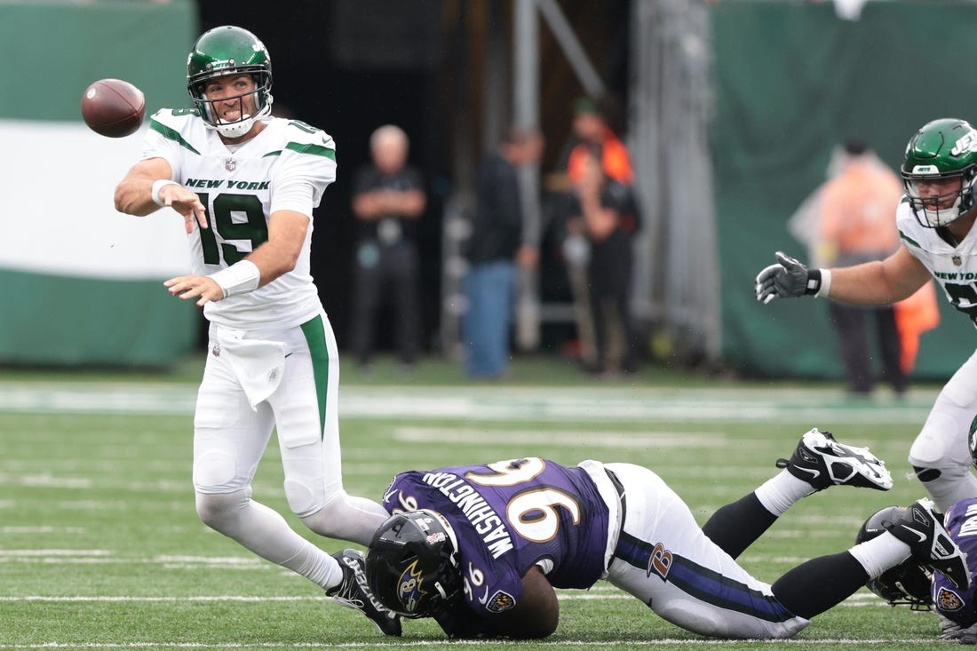 Sep 11, 2022; East Rutherford, New Jersey, USA; New York Jets quarterback Joe Flacco (19) is tackled by Baltimore Ravens defensive tackle Broderick Washington (96) while throwing the ball during the second half at MetLife Stadium. Mandatory Credit: Vincent Carchietta-USA TODAY Sports