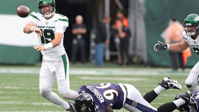 Sep 11, 2022; East Rutherford, New Jersey, USA; New York Jets quarterback Joe Flacco (19) is tackled by Baltimore Ravens defensive tackle Broderick Washington (96) while throwing the ball during the second half at MetLife Stadium. Mandatory Credit: Vincent Carchietta-USA TODAY Sports