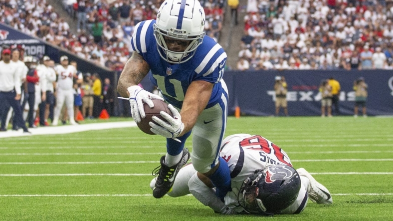 Sep 11, 2022; Houston, Texas, USA;  Indianapolis Colts wide receiver Michael Pittman Jr. (11) scores a touchdown against Houston Texans Houston Texans safety Jonathan Owens (36) in the fourth quarter  at NRG Stadium. Mandatory Credit: Thomas Shea-USA TODAY Sports