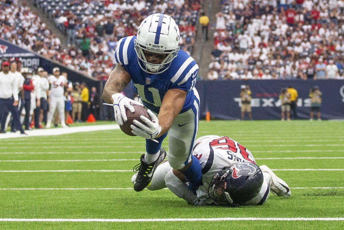 Sep 11, 2022; Houston, Texas, USA;  Indianapolis Colts wide receiver Michael Pittman Jr. (11) scores a touchdown against Houston Texans Houston Texans safety Jonathan Owens (36) in the fourth quarter  at NRG Stadium. Mandatory Credit: Thomas Shea-USA TODAY Sports