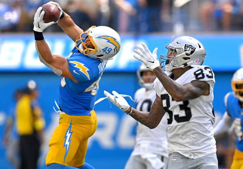 Sep 11, 2022; Inglewood, California, USA; Los Angeles Chargers linebacker Drue Tranquill (49) intercepts a pass intended for Las Vegas Raiders tight end Darren Waller (83) in the second quarter at SoFi Stadium. Mandatory Credit: Jayne Kamin-Oncea-USA TODAY Sports