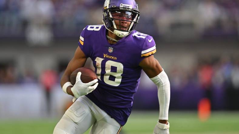 Sep 11, 2022; Minneapolis, Minnesota, USA; Minnesota Vikings wide receiver Justin Jefferson (18) scores a touchdown on a pass from quarterback Kirk Cousins (not pictured) against the Green Bay Packers during the second quarter at U.S. Bank Stadium. Mandatory Credit: Jeffrey Becker-USA TODAY Sports