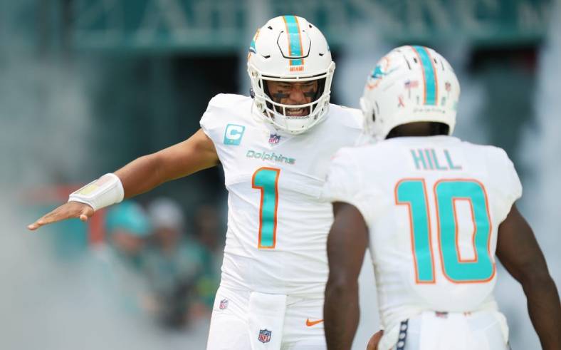 Miami Dolphins quarterback Tua Tagovailoa (1) and wide receiver Tyreek Hill (10) take the field before the opening game of the season against the New England Patriots at Hard Rock Stadium in Miami Gardens, Sept. 11, 2022.

Dolphins V Patriots Nfl Game 15
