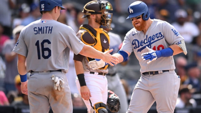 Sep 11, 2022; San Diego, California, USA; Los Angeles Dodgers third baseman Justin Turner (right) is congratulated by designated hitter Will Smith (16) after hitting a grand slam home run against the San Diego Padres during the seventh inning at Petco Park. Mandatory Credit: Orlando Ramirez-USA TODAY Sports