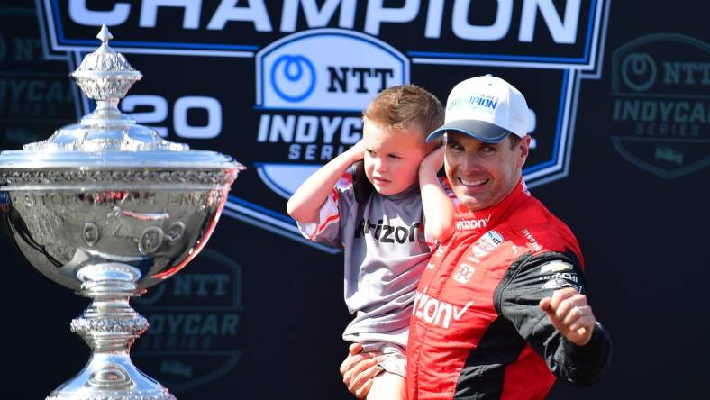 Sep 11, 2022; Salinas, California, USA; Team Penske driver Will Power (12) of Australia with son Beau William celebrates his series victory following the Grand Prix of Monterey at WeatherTech Raceway Laguna Seca. Mandatory Credit: Gary A. Vasquez-USA TODAY Sports