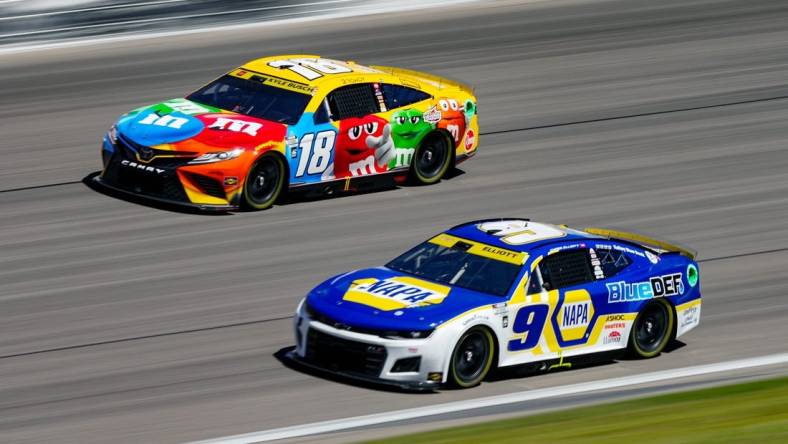 Sep 11, 2022; Kansas City, Kansas, USA; NASCAR Cup Series driver Chase Elliott (9) leads driver Kyle Busch (18) during the Hollywood Casino 400 at Kansas Speedway. Mandatory Credit: Jay Biggerstaff-USA TODAY Sports