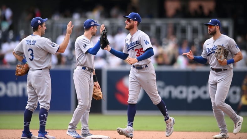 Sep 11, 2022; San Diego, California, USA; Los Angeles Dodgers players celebrate on the field after defeating the San Diego Padres at Petco Park. Mandatory Credit: Orlando Ramirez-USA TODAY Sports