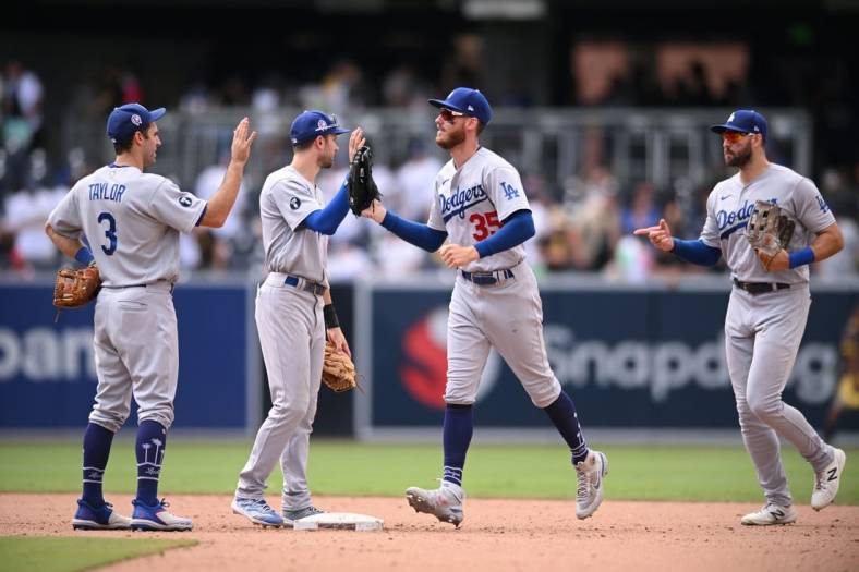 Sep 11, 2022; San Diego, California, USA; Los Angeles Dodgers players celebrate on the field after defeating the San Diego Padres at Petco Park. Mandatory Credit: Orlando Ramirez-USA TODAY Sports