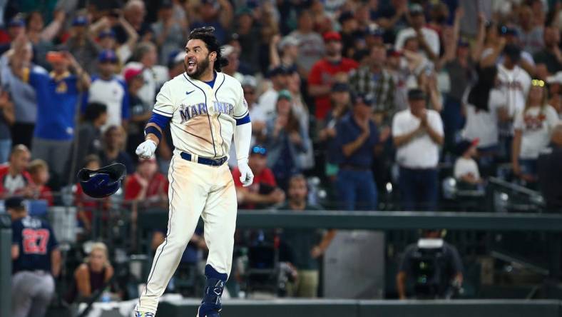 Sep 11, 2022; Seattle, Washington, USA;  Seattle Mariners third baseman Eugenio Suarez (28) throws his helmet as he celebrates his walk-off home run to beat the Atlanta Braves during the ninth inning at T-Mobile Park. The Mariners beat the Braves 8-7. Mandatory Credit: Lindsey Wasson-USA TODAY Sports