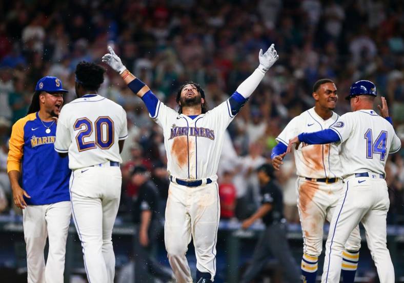 Sep 11, 2022; Seattle, Washington, USA;  Seattle Mariners third baseman Eugenio Suarez (28,center) celebrates after hitting a walk-off solo home run to beat the Atlanta Braves during the ninth inning at T-Mobile Park. The Mariners beat the Braves 8-7. Mandatory Credit: Lindsey Wasson-USA TODAY Sports