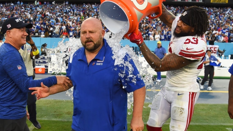 Sep 11, 2022; Nashville, Tennessee, USA; New York Giants head coach Brian Daboll receives a Gatorade bath from linebacker Oshane Ximines (53) after a win against the Tennessee Titans at Nissan Stadium. Mandatory Credit: Christopher Hanewinckel-USA TODAY Sports