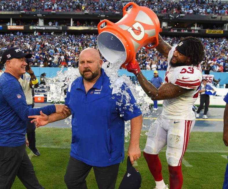 Sep 11, 2022; Nashville, Tennessee, USA; New York Giants head coach Brian Daboll receives a Gatorade bath from linebacker Oshane Ximines (53) after a win against the Tennessee Titans at Nissan Stadium. Mandatory Credit: Christopher Hanewinckel-USA TODAY Sports