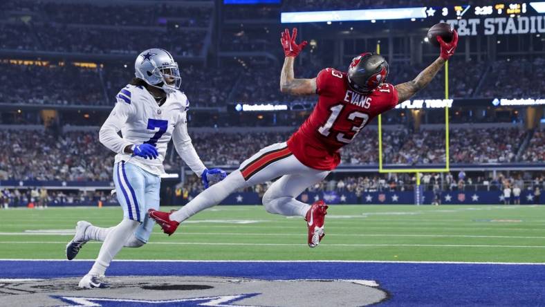 Sep 11, 2022; Arlington, Texas, USA;  Tampa Bay Buccaneers wide receiver Mike Evans (13) makes a leaping touchdown catch over Dallas Cowboys cornerback Trevon Diggs (7) during the third quarter at AT&T Stadium. Mandatory Credit: Kevin Jairaj-USA TODAY Sports