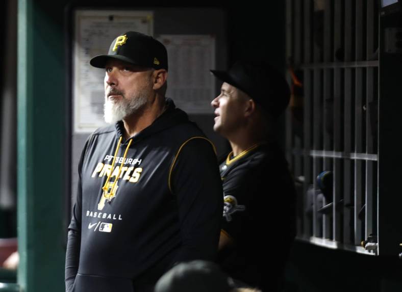 Sep 12, 2022; Cincinnati, Ohio, USA; Pittsburgh Pirates manager Derek Shelton (17) watches from the dugout against the Cincinnati Reds during the eighth inning at Great American Ball Park. Mandatory Credit: David Kohl-USA TODAY Sports