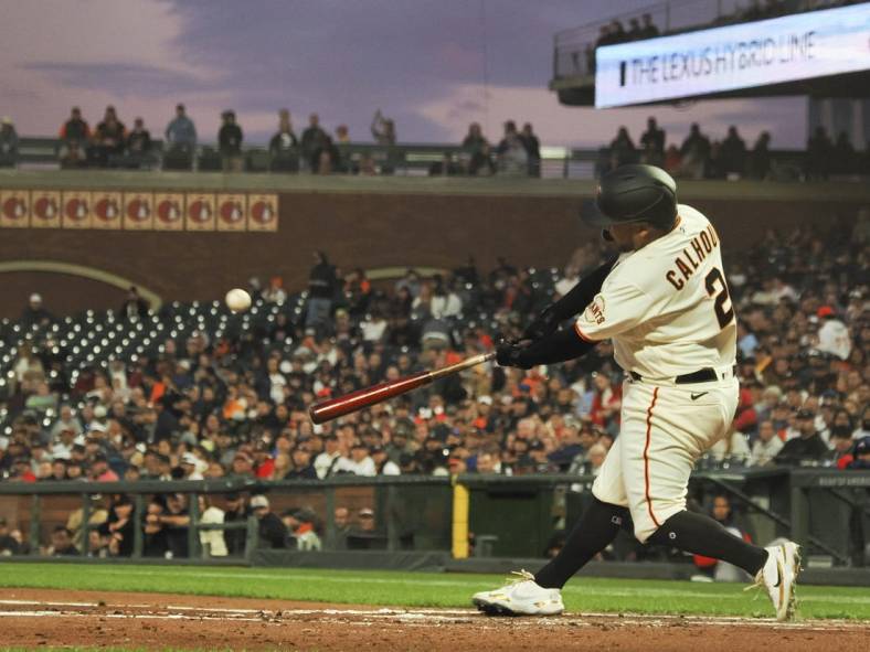 Sep 12, 2022; San Francisco, California, USA; San Francisco Giants designated hitter Willie Calhoun (2) hits an RBI single against the Atlanta Braves during the second inning at Oracle Park. Mandatory Credit: Kelley L Cox-USA TODAY Sports