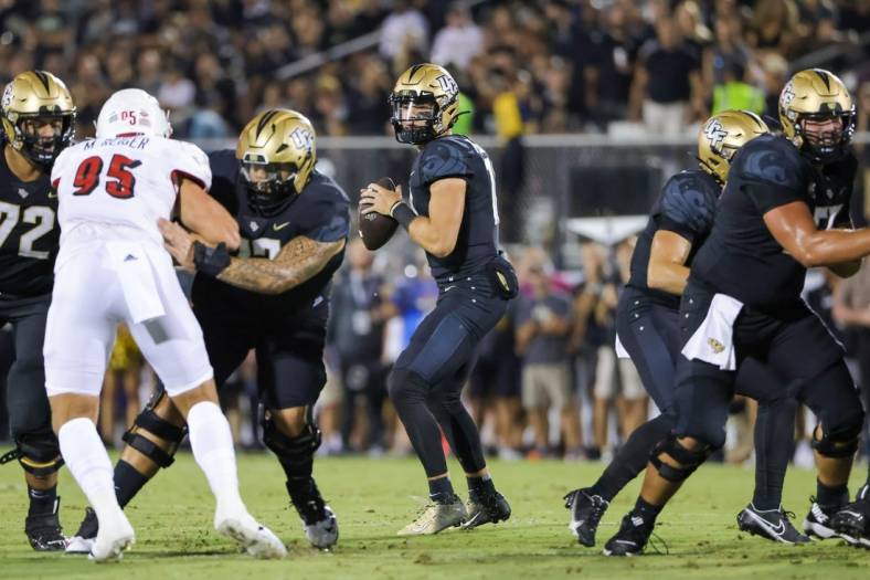 Sep 9, 2022; Orlando, Florida, USA; UCF Knights quarterback John Rhys Plumlee (10) drops back to pass during the first quarter against the Louisville Cardinals at FBC Mortgage Stadium. Mandatory Credit: Mike Watters-USA TODAY Sports