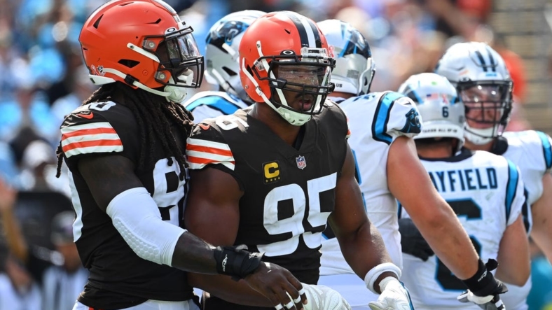 Sep 11, 2022; Charlotte, North Carolina, USA; Cleveland Browns defensive end Myles Garrett (95) reacts with defensive end Jadeveon Clowney (90) after sacking Carolina Panthers quarterback Baker Mayfield (6) in the third quarter at Bank of America Stadium. Mandatory Credit: Bob Donnan-USA TODAY Sports