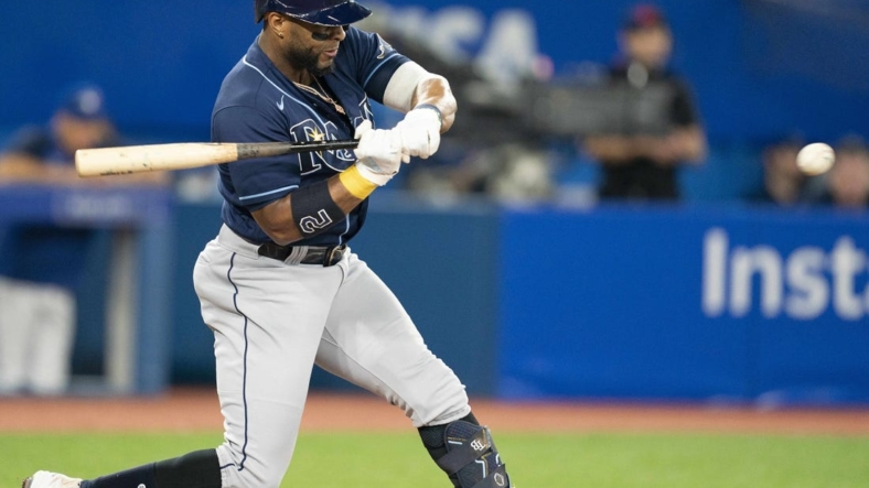 Sep 13, 2022; Toronto, Ontario, CAN; Tampa Bay Rays third baseman Yandy Diaz (2) hits a single against the Toronto Blue Jays during the third inning at Rogers Centre. Mandatory Credit: Nick Turchiaro-USA TODAY Sports