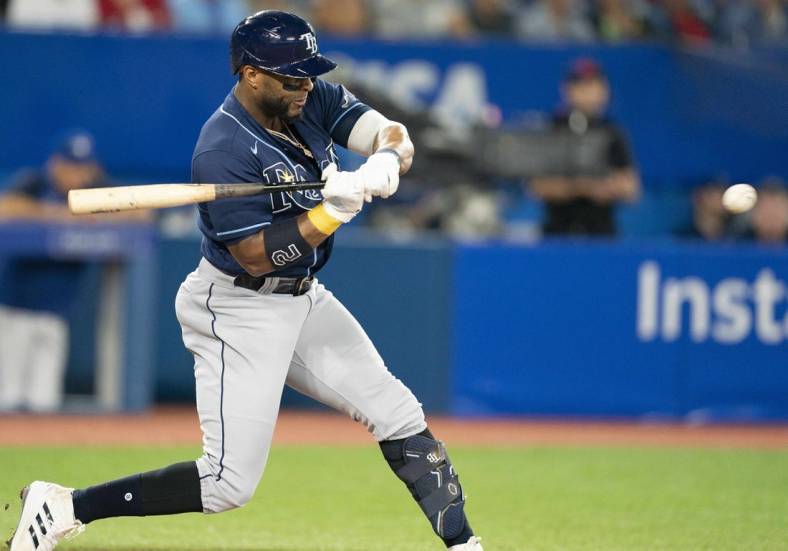 Sep 13, 2022; Toronto, Ontario, CAN; Tampa Bay Rays third baseman Yandy Diaz (2) hits a single against the Toronto Blue Jays during the third inning at Rogers Centre. Mandatory Credit: Nick Turchiaro-USA TODAY Sports
