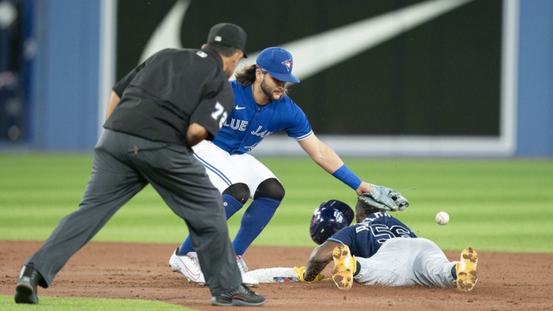 Sep 13, 2022; Toronto, Ontario, CAN; Tampa Bay Rays right fielder Randy Arozarena (56) steals second base ahead of the tag from Toronto Blue Jays shortstop Bo Bichette (11) during the third inning at Rogers Centre. Mandatory Credit: Nick Turchiaro-USA TODAY Sports