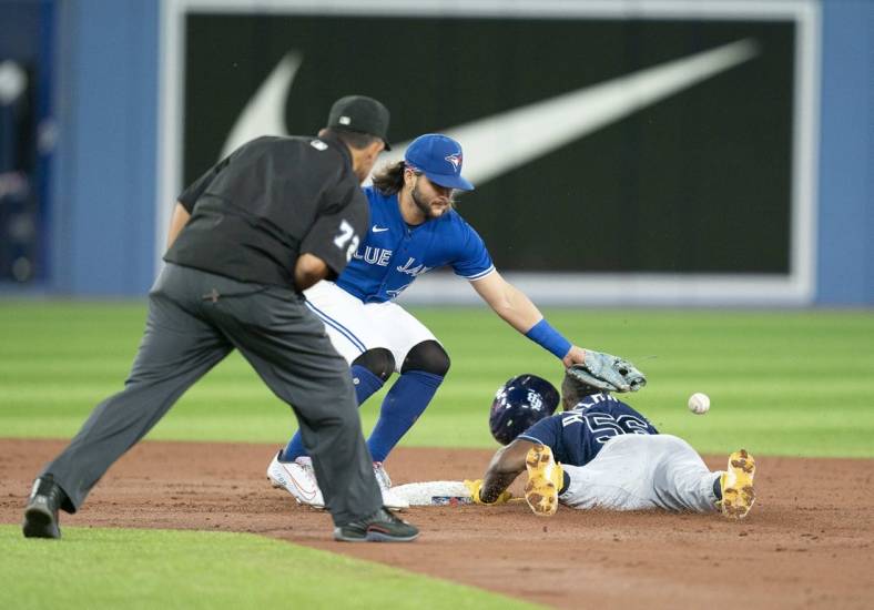Sep 13, 2022; Toronto, Ontario, CAN; Tampa Bay Rays right fielder Randy Arozarena (56) steals second base ahead of the tag from Toronto Blue Jays shortstop Bo Bichette (11) during the third inning at Rogers Centre. Mandatory Credit: Nick Turchiaro-USA TODAY Sports