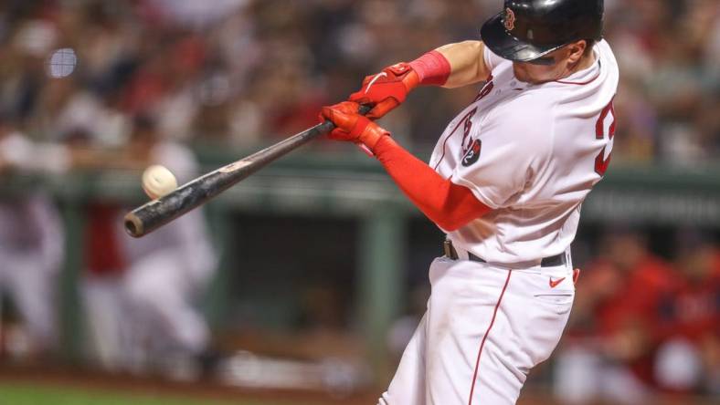 Sep 13, 2022; Boston, Massachusetts, USA; Boston Red Sox catcher Reese McGuire (3) hits a home run during the third inning against the New York Yankees at Fenway Park. Mandatory Credit: Paul Rutherford-USA TODAY Sports