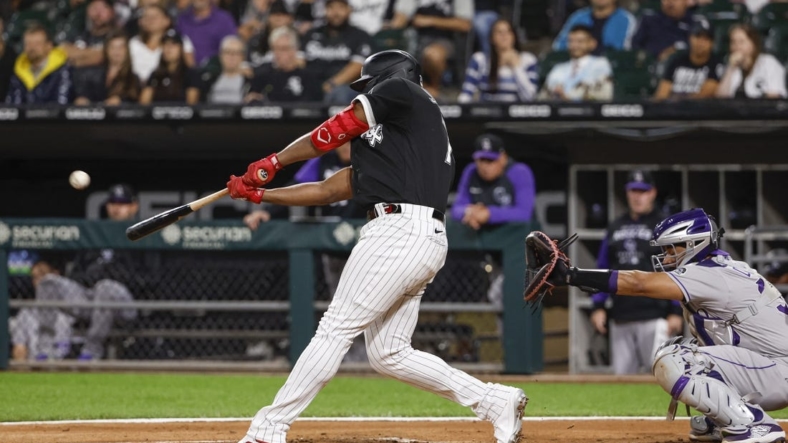 Sep 13, 2022; Chicago, Illinois, USA; Chicago White Sox left fielder Eloy Jimenez (74) hits a three-run home run against the Colorado Rockies during the first inning at Guaranteed Rate Field. Mandatory Credit: Kamil Krzaczynski-USA TODAY Sports